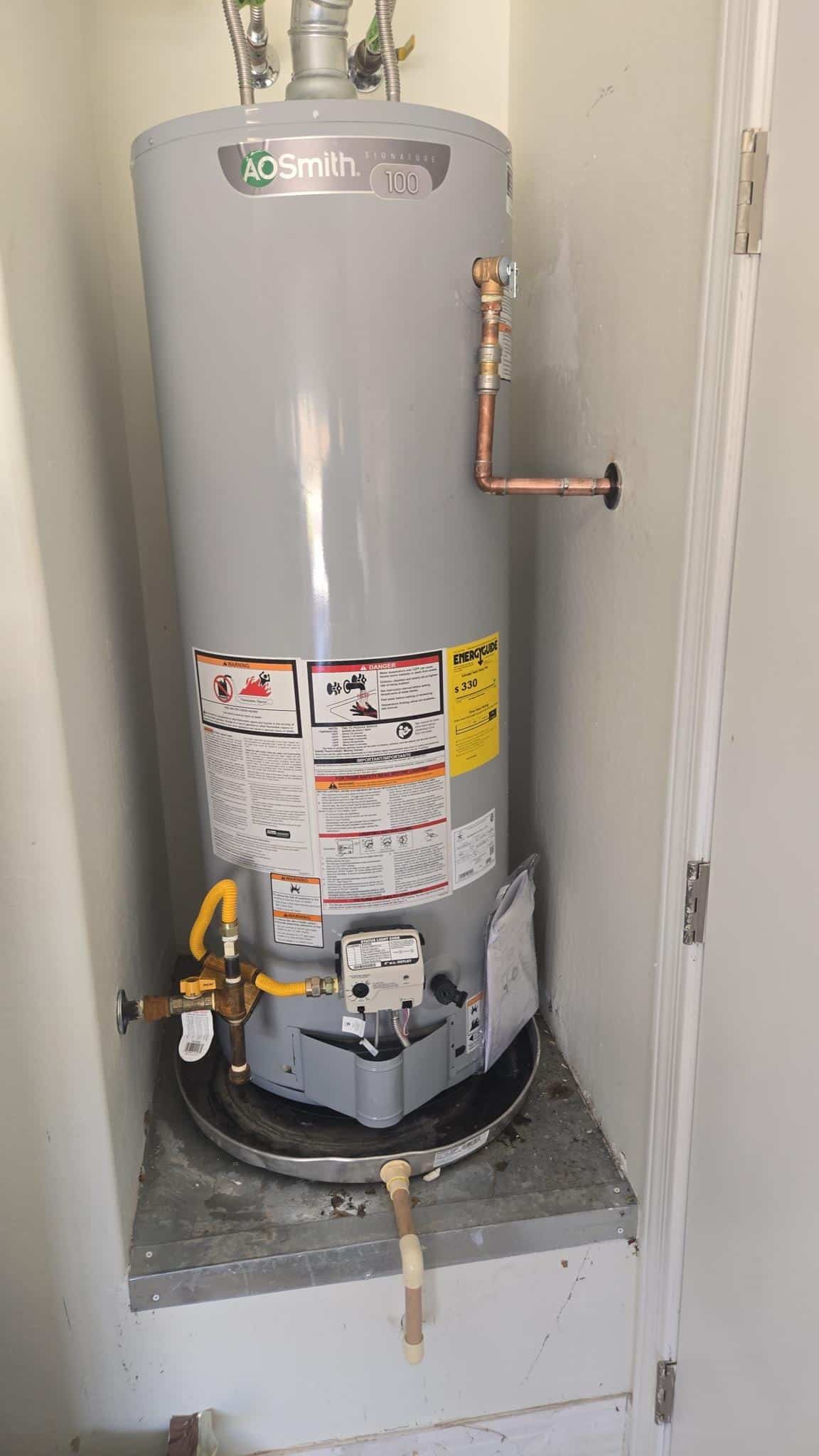 Breasy repairing a water heater affected by hard water scale in a Scottsdale rental