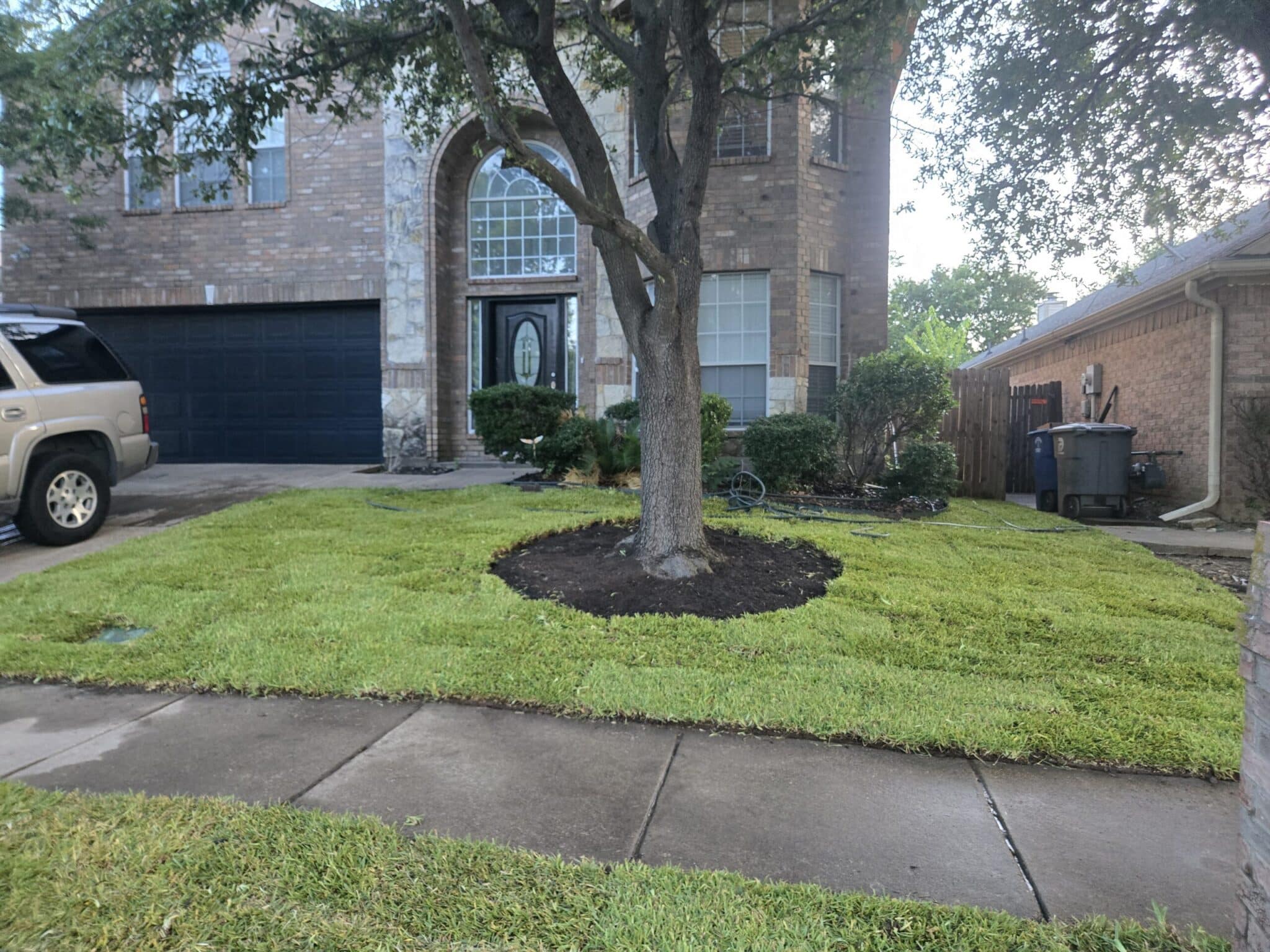 Compacted red clay soil on a sloped Atlanta, GA yard before sod installation