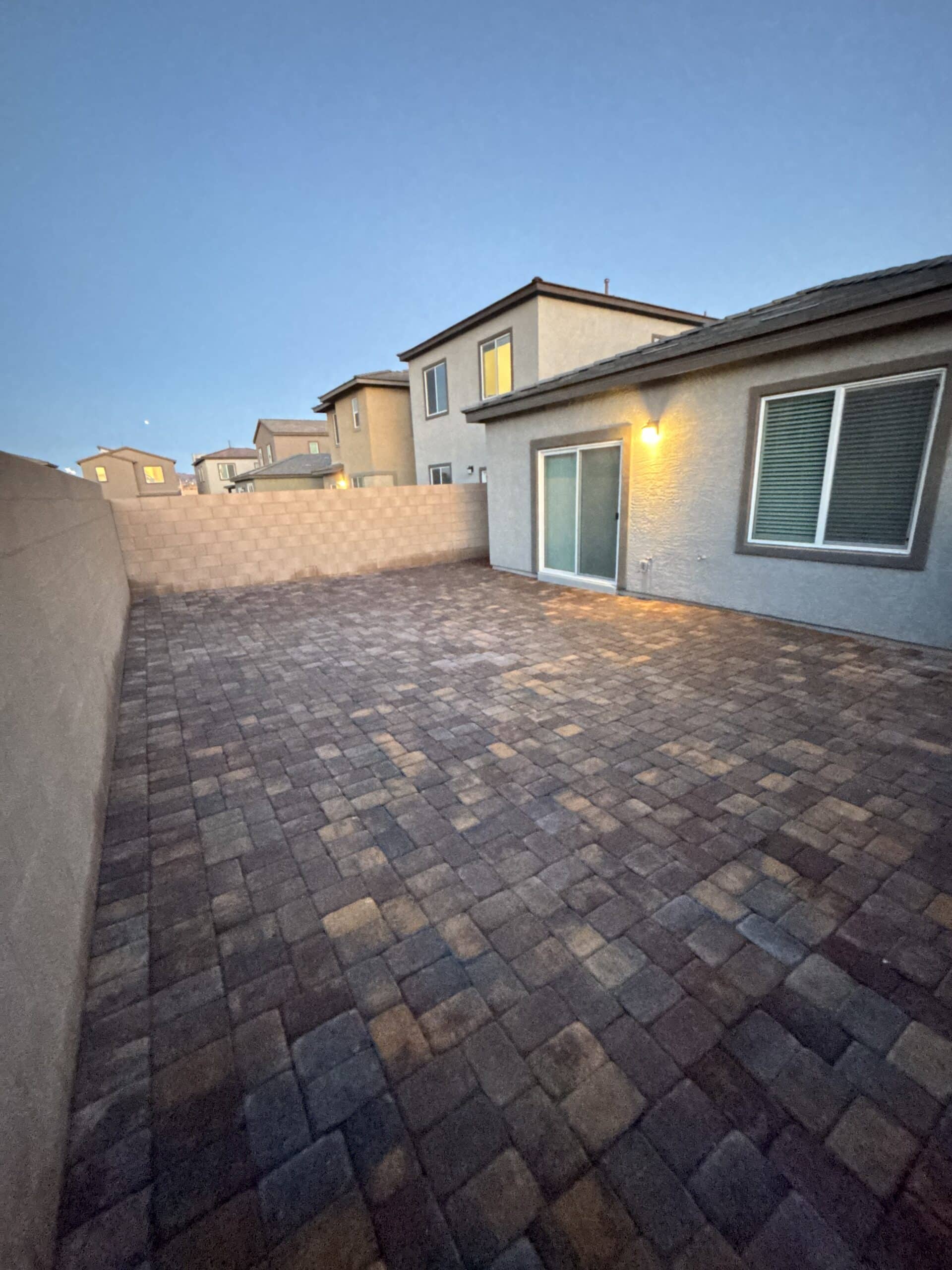 Finished paver patio installation near a sliding glass door